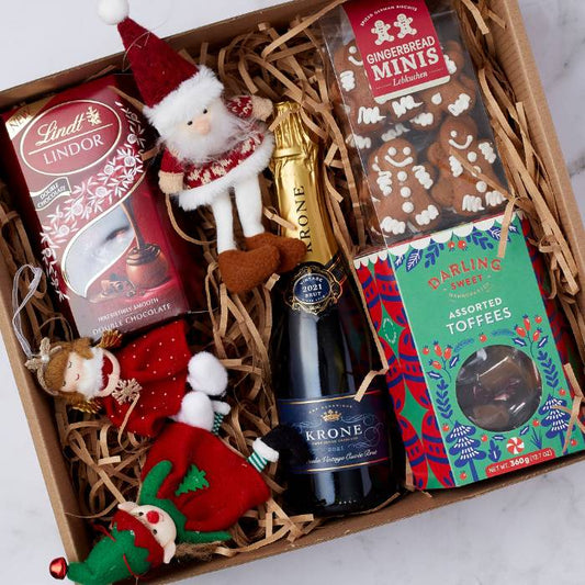 Christmas Spirit Gift Box for Him featuring Lindt chocolate, Krone sparkling wine, gingerbread cookies, assorted toffees, and festive ornaments in a beautifully presented box.