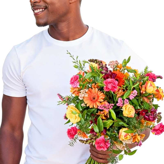 Day-Maker Blooms bouquet close-up—bright mixed blooms and lush greenery held in hand, ready to gift | Flower Guy