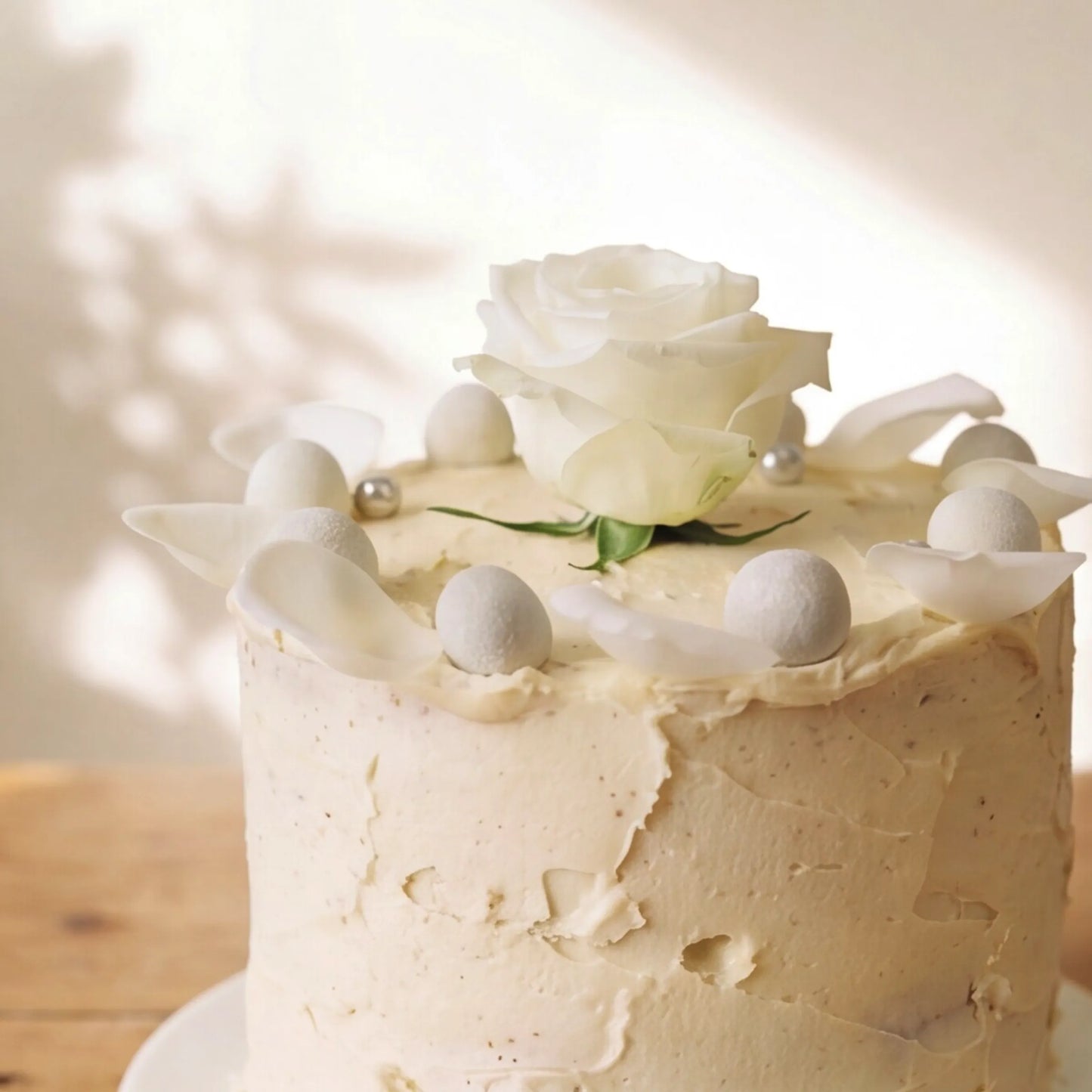 Macro of white rose petals and silver pearls on Elegant Rose Celebration Cake by Flower Guy Cape Town