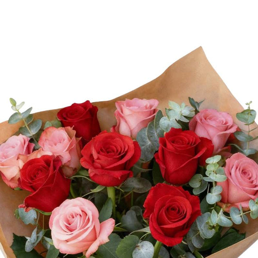 Nailed It rose bouquet close-up—red roses with blush accents and lush greenery in kraft wrap, gift-ready | Flower Guy