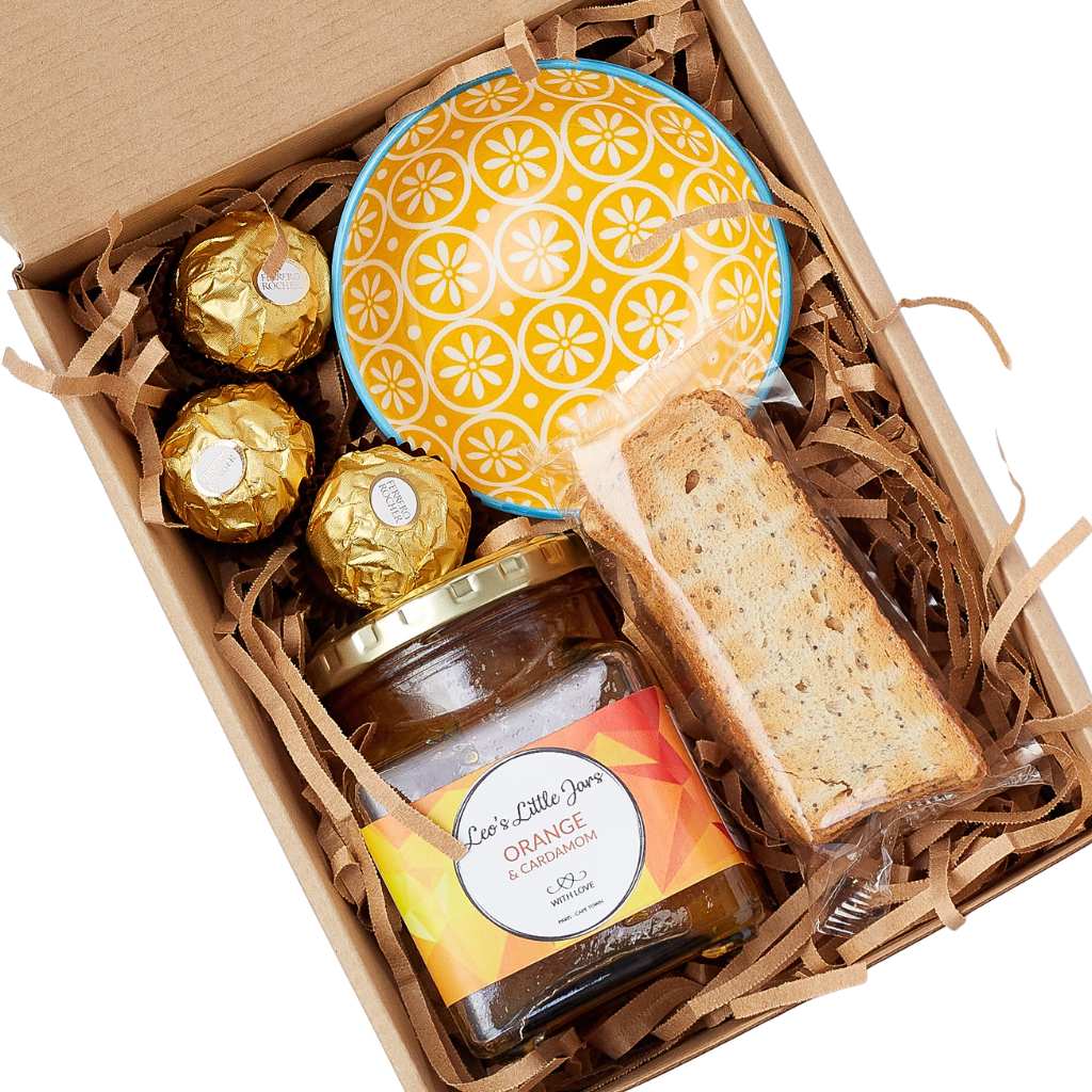 Sunshine in a Gift Box gift hamper—boxed treats with marmalade, biscotti, Ferrero Rocher and ceramic bowl, top view | Flower Guy
