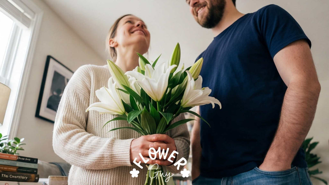 Couple sharing a moment with a hand-tied white lily bouquet at home — Flower Guy delivery