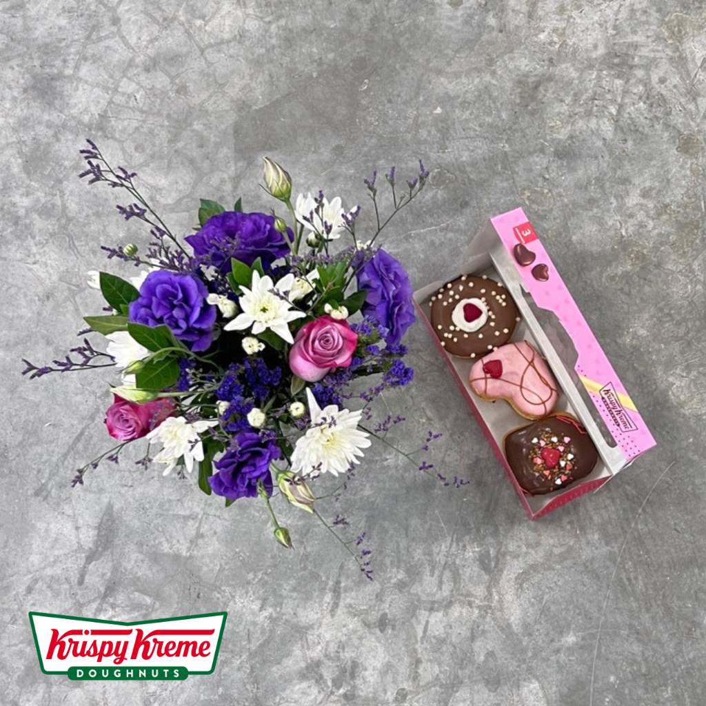 Purple lisianthus and pink roses in Blossom Delight arrangement with doughnuts by Flower Guy.