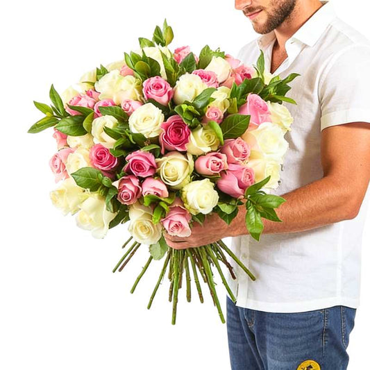 Blush Rush roses delivered—person holding an oversized blush-toned rose bouquet with greenery | Flower Guy