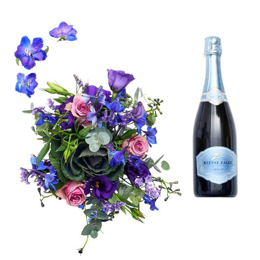 Bubbles and Pink gift set—pink floral arrangement with greenery beside a sparkling wine bottle, styled for celebration | Flower Guy