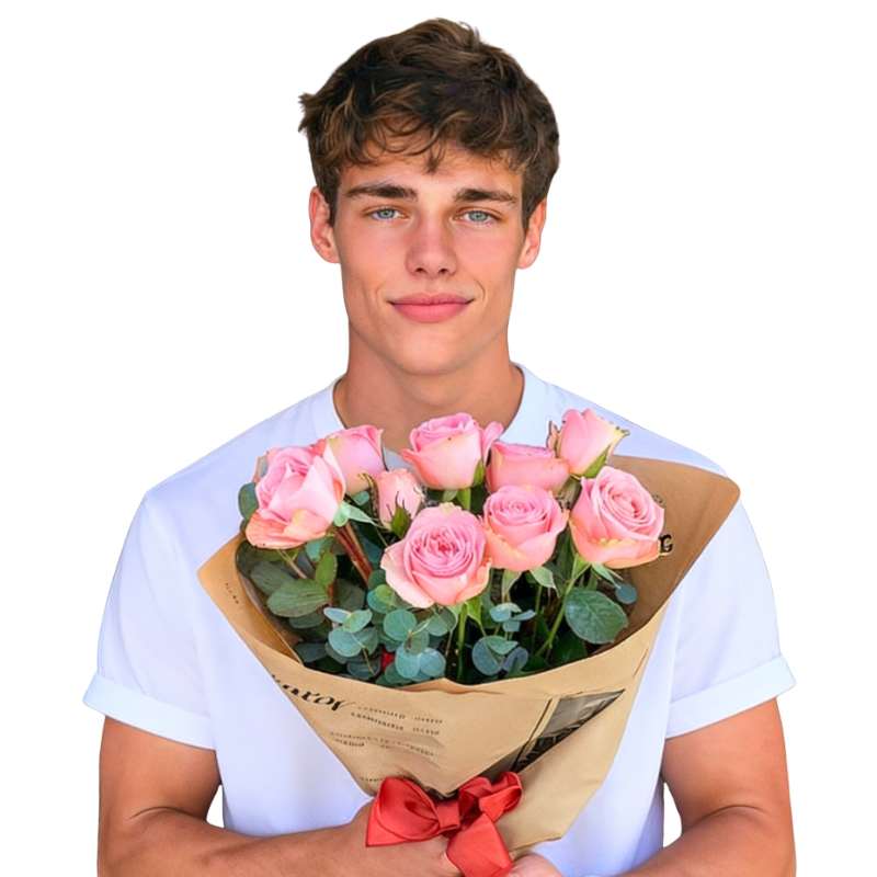 Charming Blooms Rose Bouquet—person holding 10 soft pink roses with greenery, wrapped in kraft paper with ribbon | Flower Guy