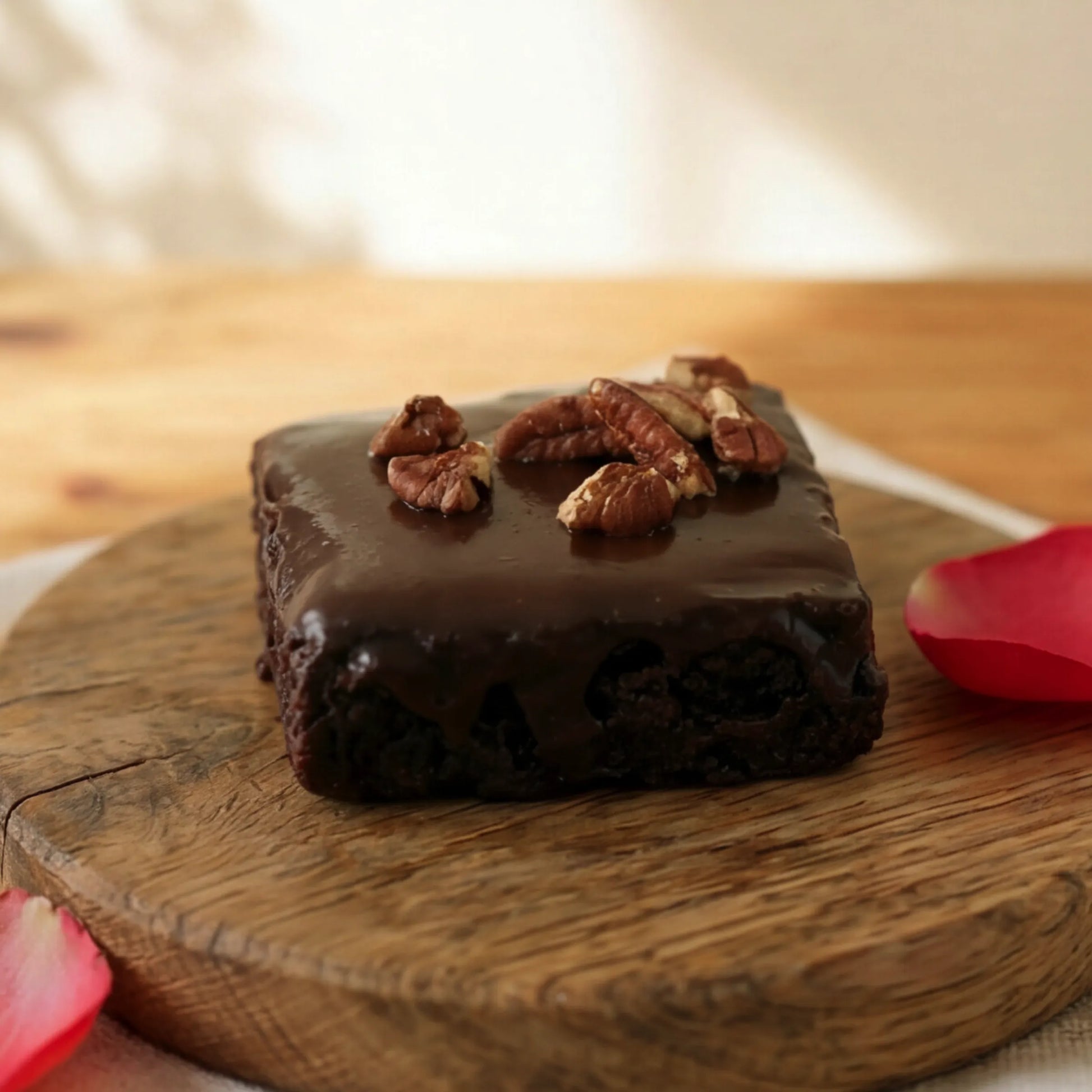 Side view of dense fudgy Chocolate Brownie with chocolate glaze and pecans, hand-made in Cape Town