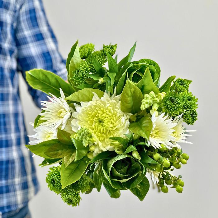 Flower Guy holding Handcrafted Chrysanthemum Bouquet with Kale, a green and white flower gift.