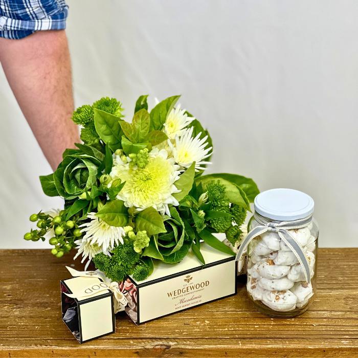 White and green Chrysanthemum Bouquet with Meringues and Nougat being held by a male florist - Flower Guy