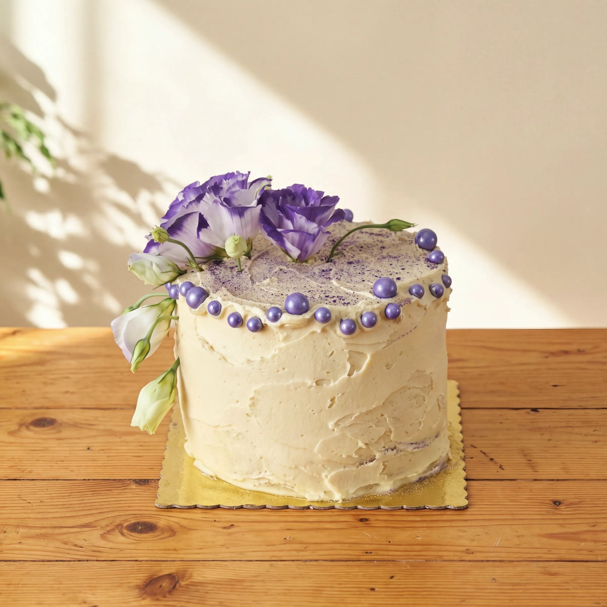 Creamy Violet Dream Cake with bicolour purple lisianthus, purple pearls and dusted top by Flower Guy