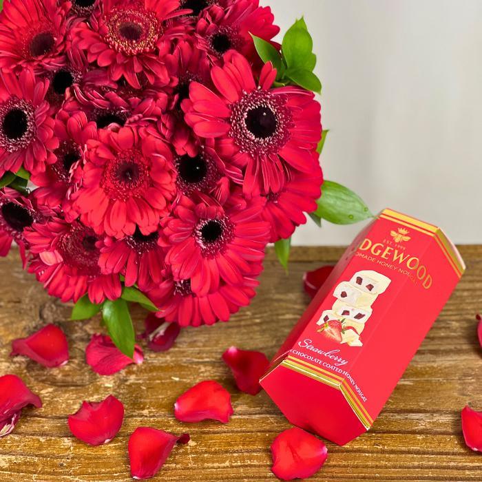 Wedgewood Handmade Honey Nougat Giftbox paired with Crimson Kiss Bouquet on wooden tabletop with red rose petals - Flower Guy