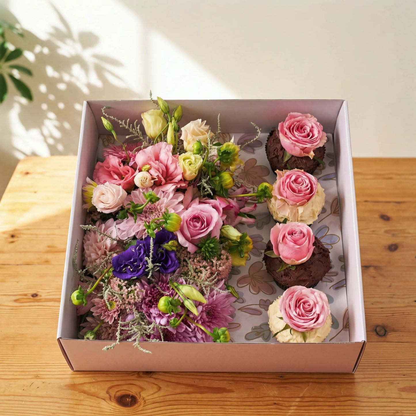 Cupcake Bloom Box with pink roses and chocolate cupcakes topped with fresh roses by Flower Guy Cape Town