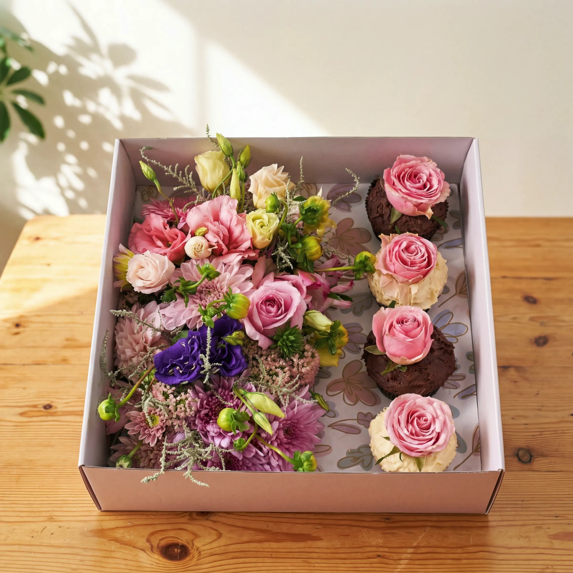 Cupcake Bloom Box with pink roses and chocolate cupcakes topped with fresh roses by Flower Guy Cape Town