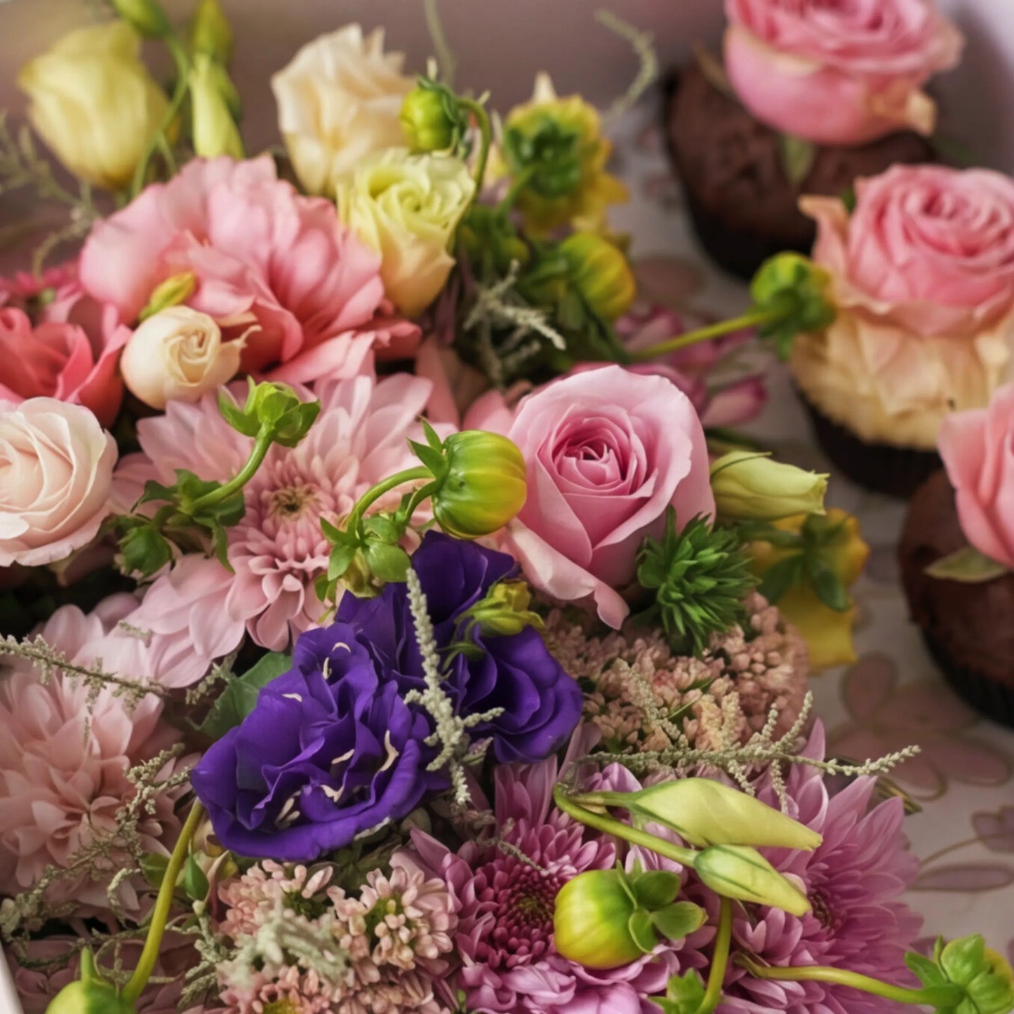 Macro of pink roses, purple lisianthus and dahlias in Cupcake Bloom Box by Flower Guy Cape Town