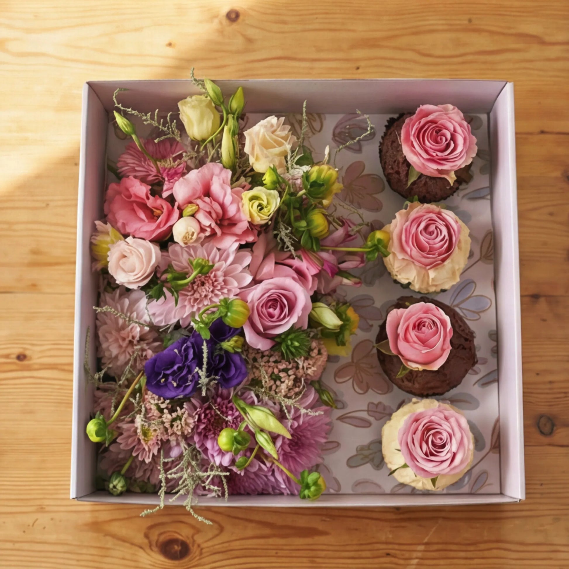 Top-down Cupcake Bloom Box with multi-tonal florals and 4 rose-topped cupcakes by Flower Guy Cape Town