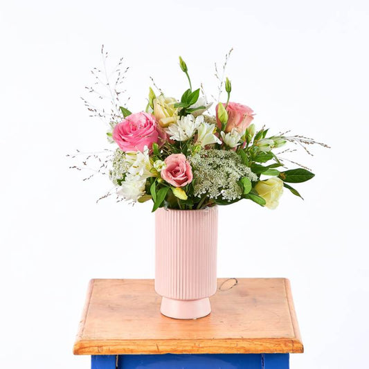 Dear Heart vase flower arrangement with blush pink roses, creamy white blooms and airy greenery on wooden board | Flower Guy