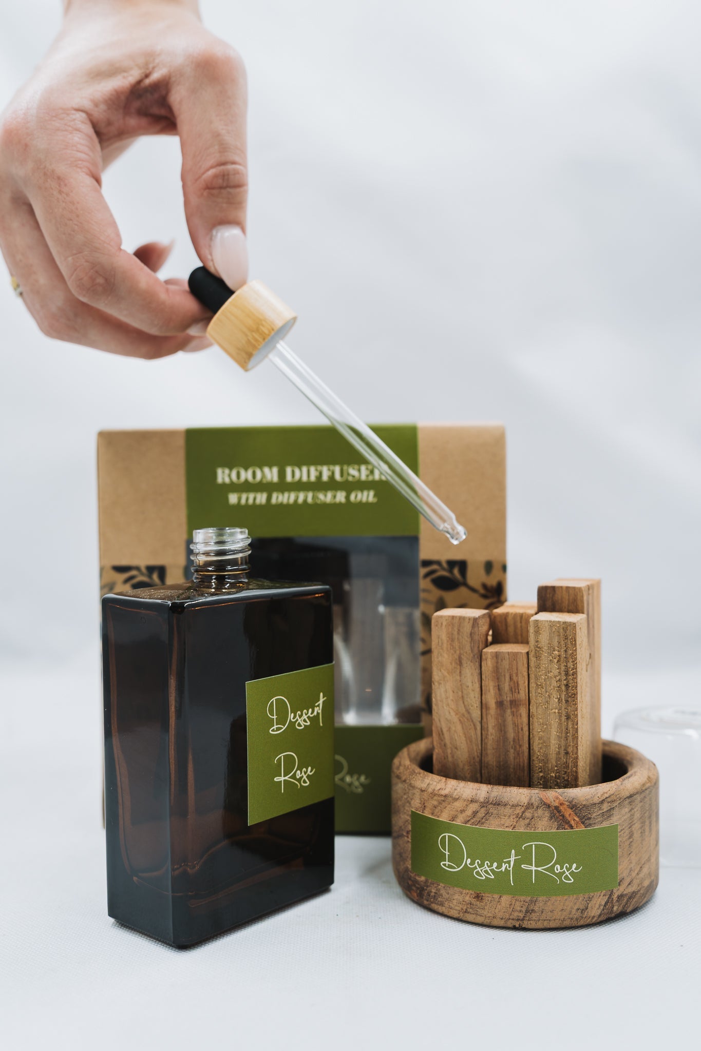 Room diffuser with essential oil and wooden sticks on a white background