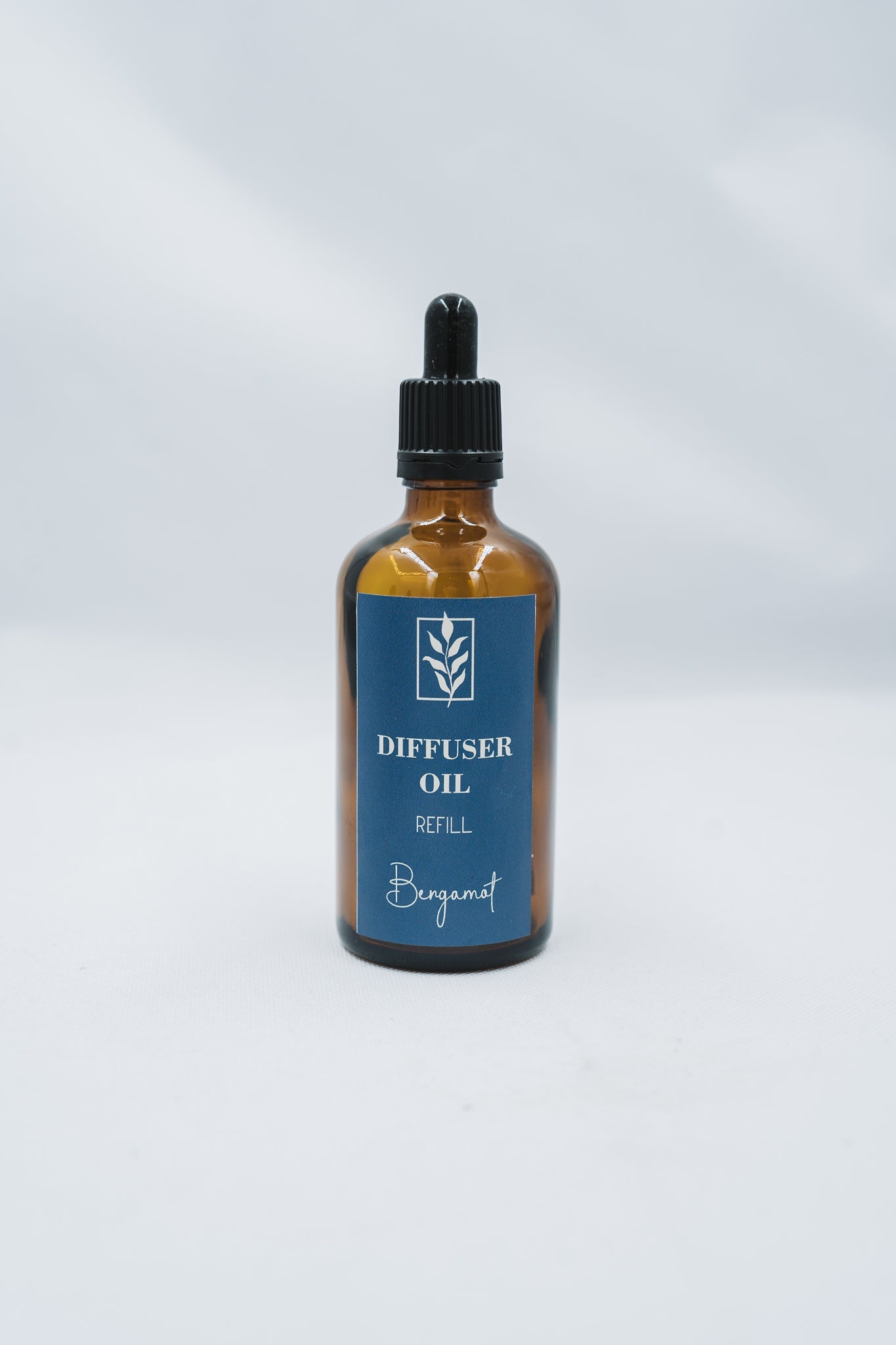 Bottle of diffuser oil labeled 'Bergamot' on a white background