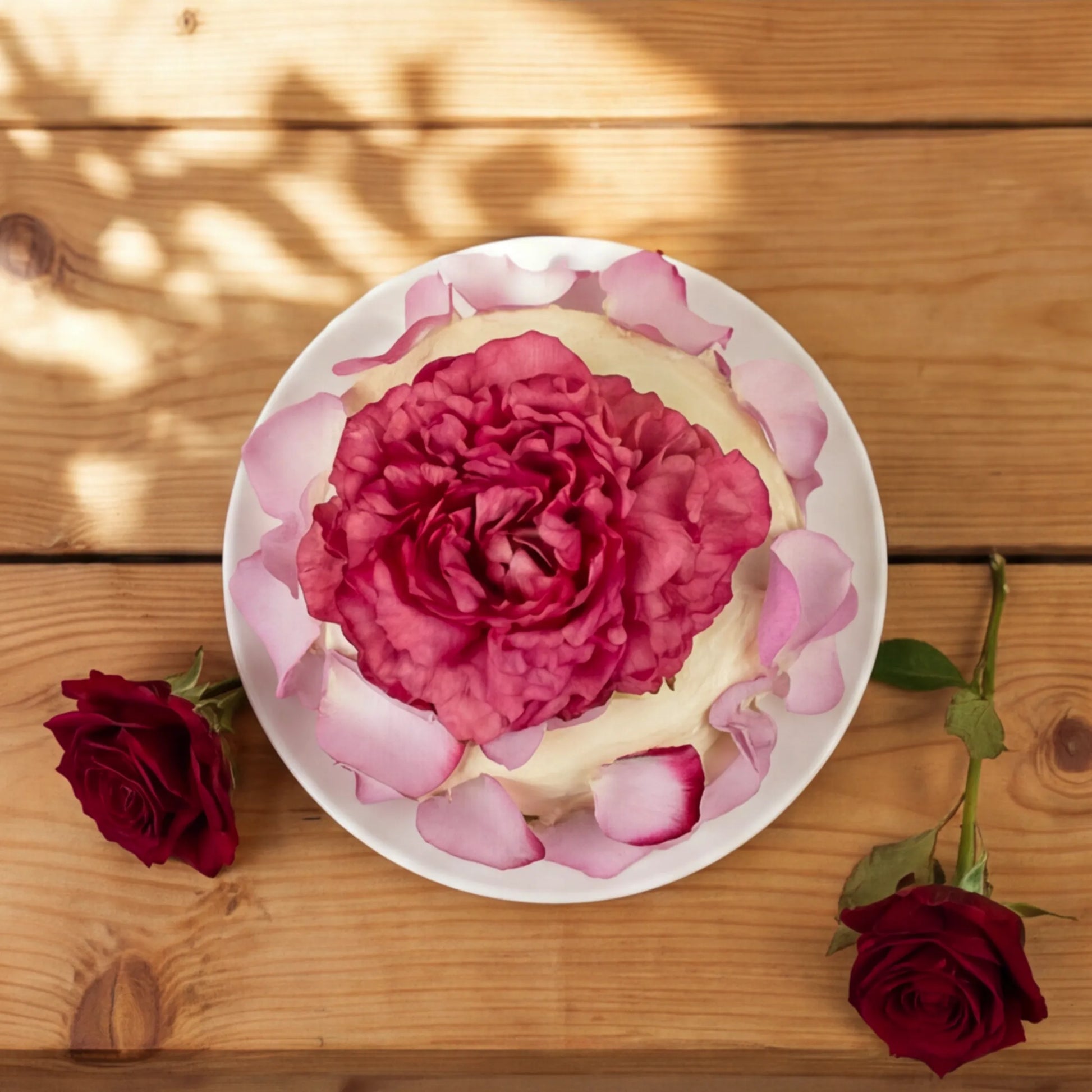 Top-down Elegance Rouge Cake with magenta peony centre and pink rose petals, hand-decorated in Cape Town