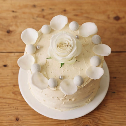 Close-up of white rose centre and silver pearl crown on Elegant Rose Celebration Cake by Flower Guy