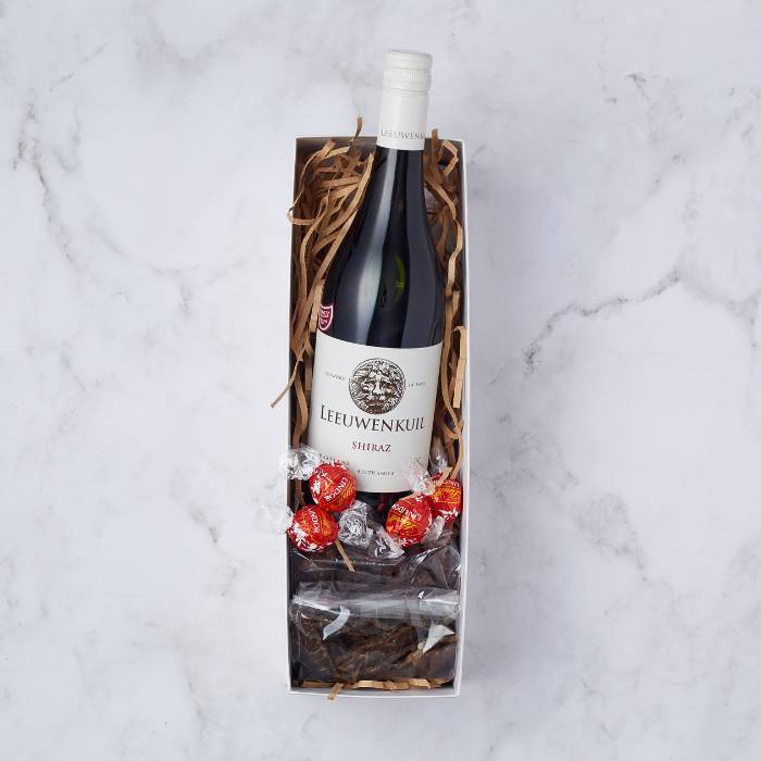 Shiraz & Chocolate Delight gift box featuring a bottle of Leeuwenkuil Shiraz, Lindt chocolate truffles, and biltong by Flower Guy.