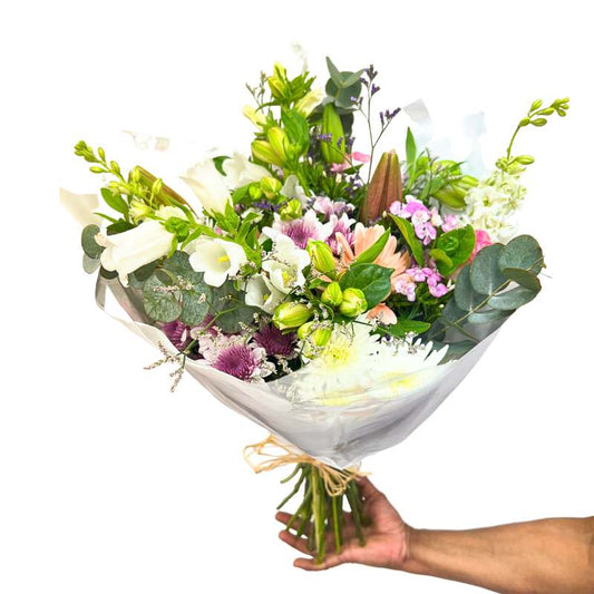 Free Spirit Bouquet close-up—wild, airy pink and green mixed bouquet held in hand, gift-ready wrap | Flower Guy