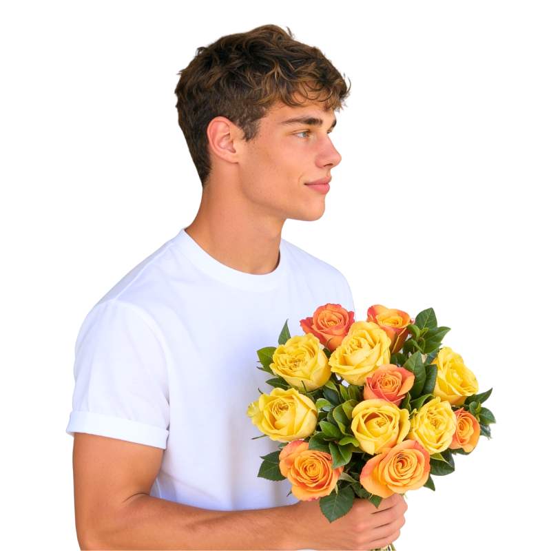 Glow Getter bouquet—person holding 12 yellow and orange roses with lush greenery, gift-wrapped | Flower Guy