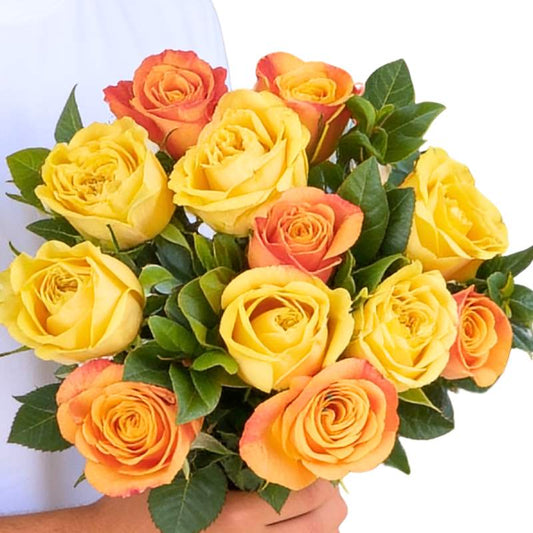 Glow Getter roses close-up—12 yellow and orange rose bouquet with greenery, wrapped and ribbon-tied | Flower Guy