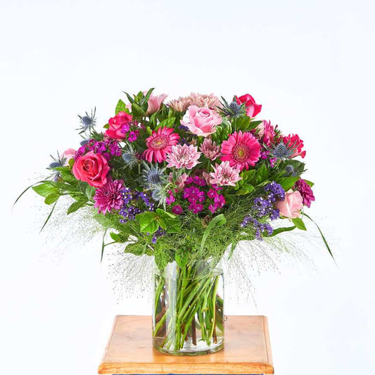 Hot Pink Therapy flower arrangement in clear glass vase with hot pink roses, gerberas and greenery | Flower Guy