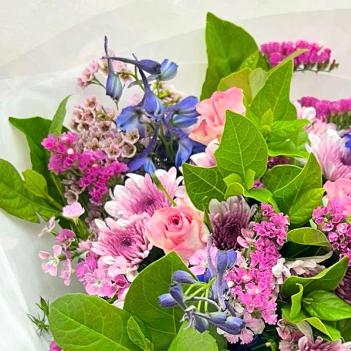 Jump for Joy Bouquet close-up—pastel pink and purple blooms with greenery in a hand-tied, gift-ready bouquet | Flower Guy