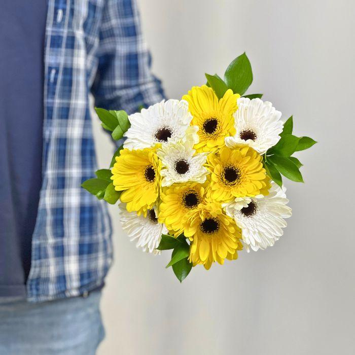 Close-up of male florist holding white and yellow gerbera daisies in Lemon Meringue Bouquet - Flower Guy