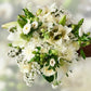 Close up of white flower bouquet with roses, alstroemeria and lily flowers - Flower Guy
