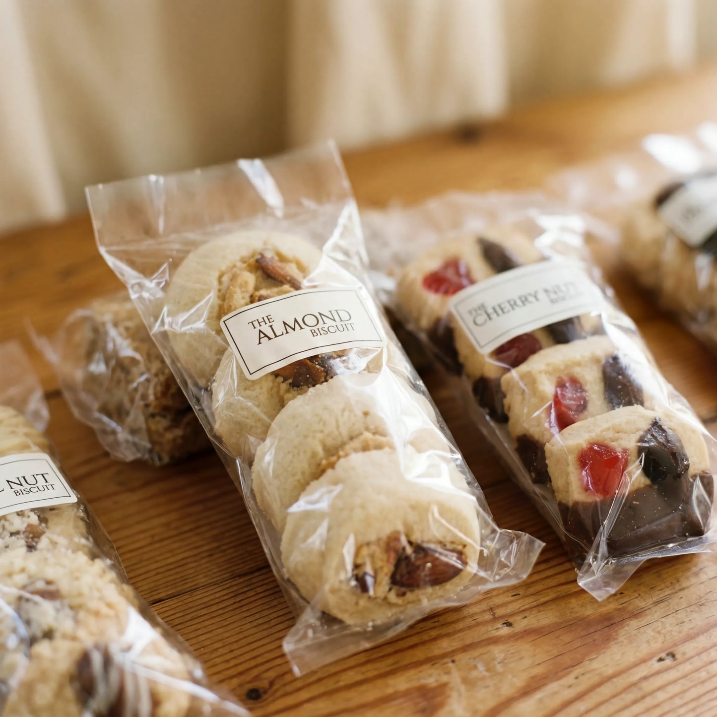 Close-up of Almond Biscuit and Cherry Nut Biscuit sleeves from the Luxury Biscuits Small box by Flower Guy