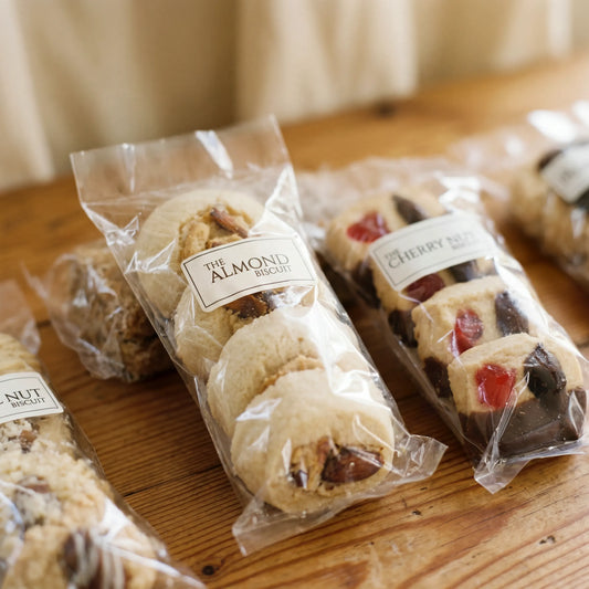 Close-up of Almond Biscuit and Cherry Nut Biscuit sleeves from the Luxury Biscuits Small box by Flower Guy
