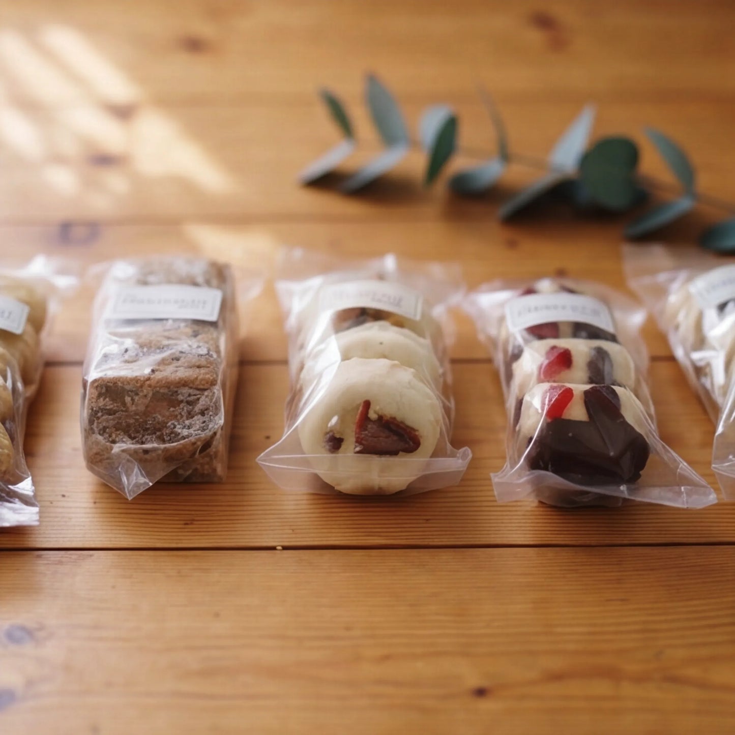 Side angle of the five Luxury Biscuits Small sleeves with brazil, walnut, almond, cherry and pecan biscuits