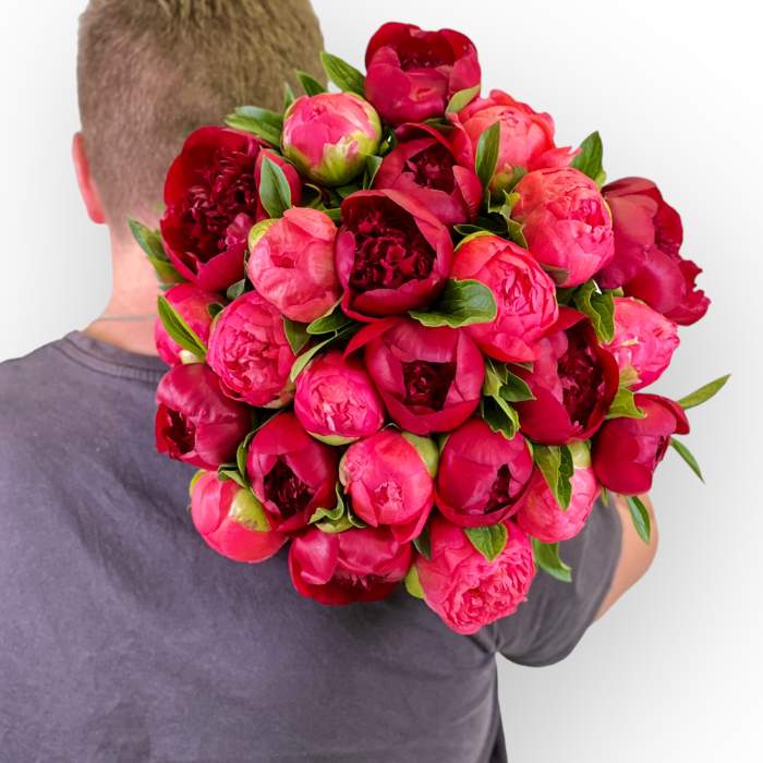 Flower Guy's peony flower bouquet ready for delivery held by Flower Guy