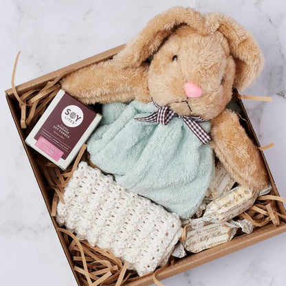 Close-up of Rabbit Dudu Gift Box with a soft rabbit comforter, candle, handmade blanket, and sweets arranged neatly.