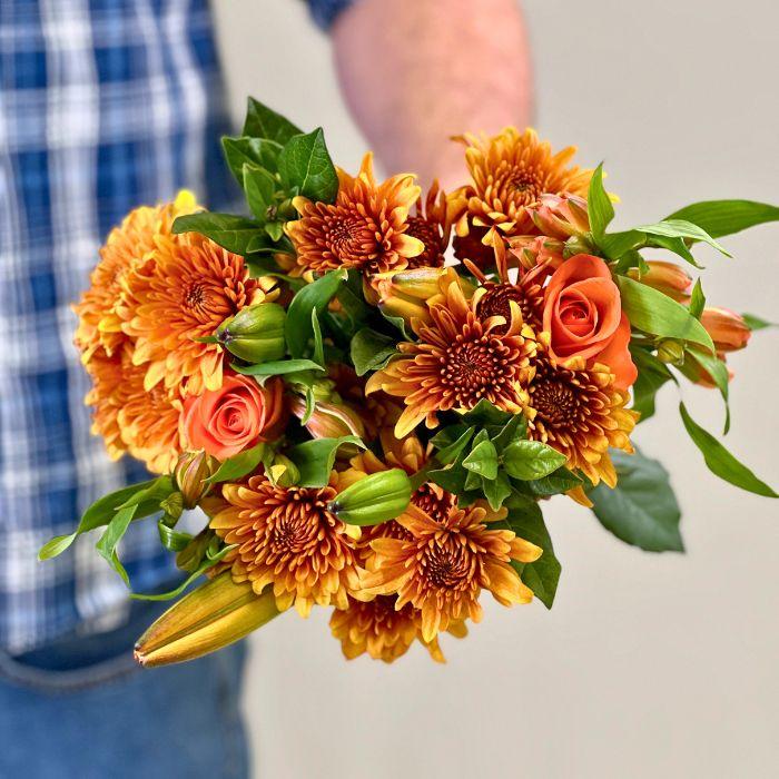Signal Hill Sunset Bouquet wrapped in eco-friendly paper and filled with orange flowers - Flower Guy
