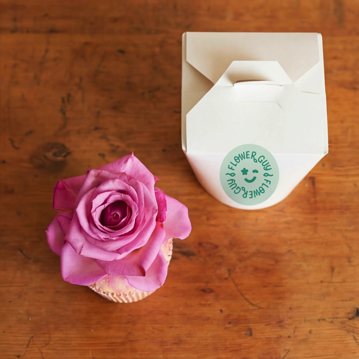 Top view of Single Vanilla Cupcake with real pink rose, edible glitter and Flower Guy gift box