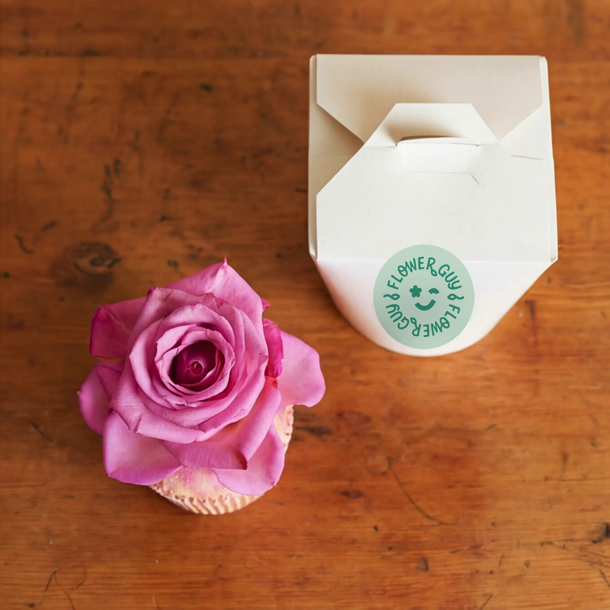 Top view of Single Vanilla Cupcake with real pink rose, edible glitter and Flower Guy gift box