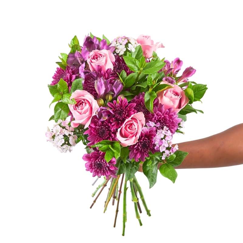 Spring Blossom flower bouquet—hand-tied pink roses and purple chrysanthemums with greenery, held in hand | Flower Guy