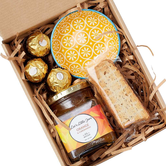 Sunshine in a Gift Box gift hamper—boxed treats with marmalade, biscotti, Ferrero Rocher and ceramic bowl, top view | Flower Guy