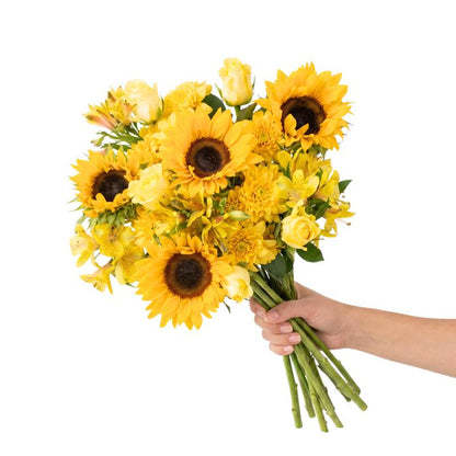 Sunstruck yellow flower bouquet from Flower Guy with large sunflowers, yellow roses, yellow alstroemeria and yellow chrysanthemums, hand-tied with natural raffia.