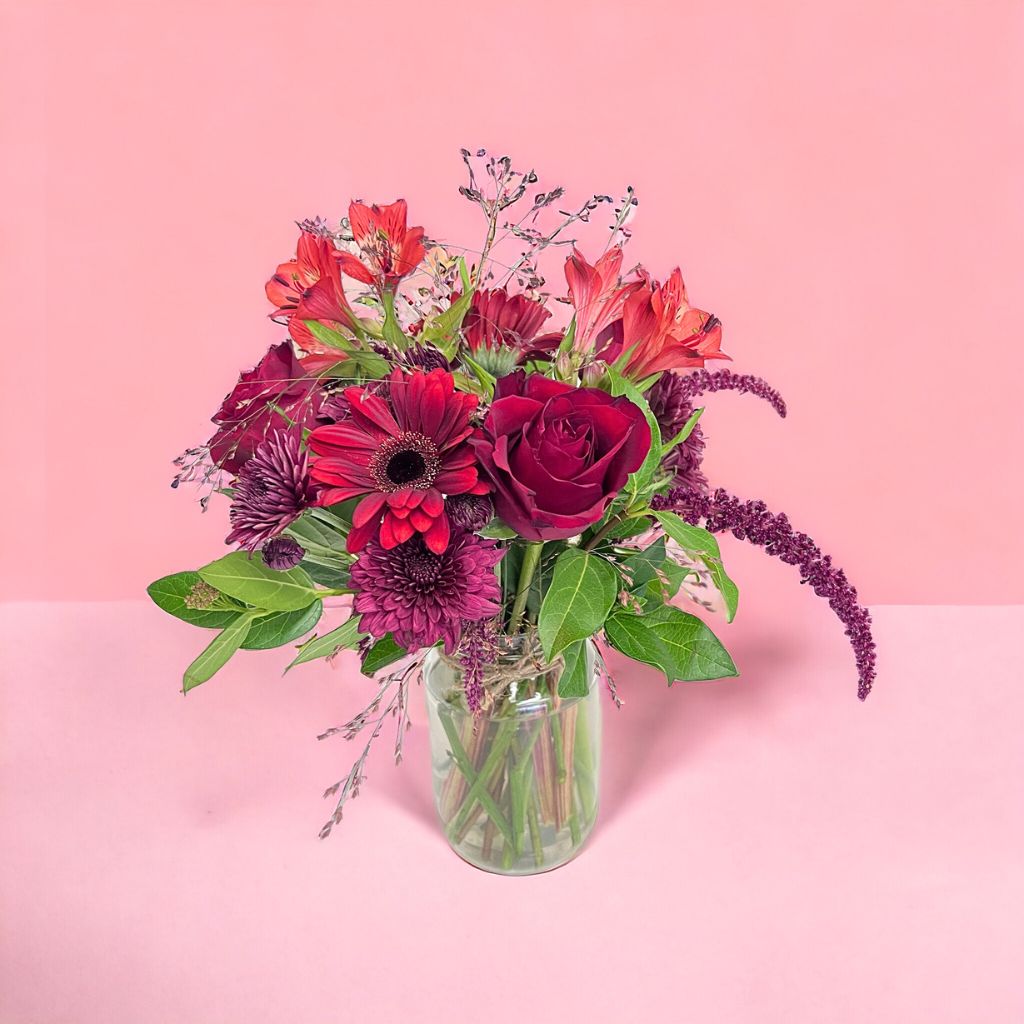 Elegant vase of red roses and gerberas with alstroemeria by Flower Guy.