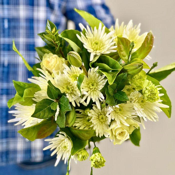 Table Bay Blooms Bouquet with White Chrysanthemums, lilies and greenery held by Flower Guy