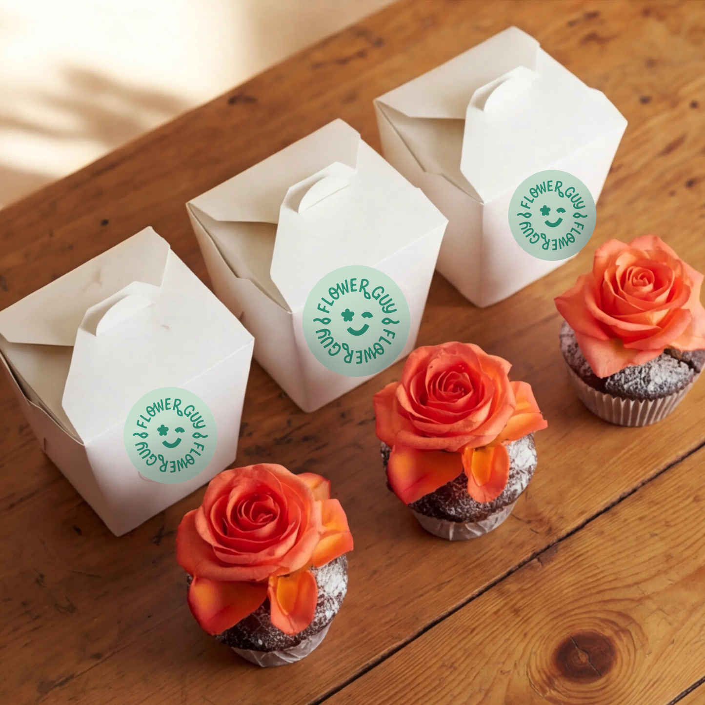 Three chocolate cupcakes with orange rose toppers paired with their individual Flower Guy gift boxes, Cape Town same-day cupcake add-on for sharing
