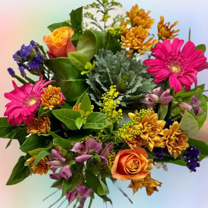 Close-up of the radiant alstroemeria, goldenrod, statice, gerberas and roses in Unicorn Flower Bouquet