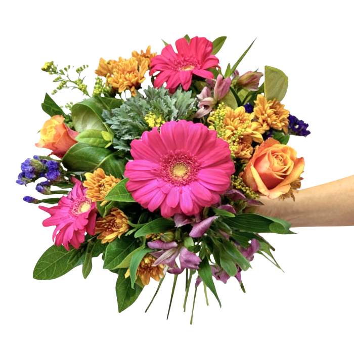 Unicorn Flower Bouquet—hand holding bright mixed bouquet with roses, pink gerberas, golden blooms and greenery, gift-ready | Flower Guy
